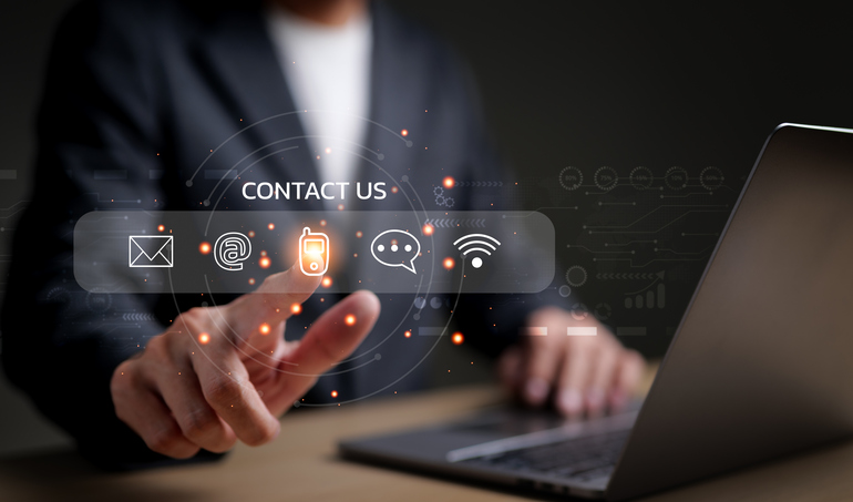 Contact us - hands on laptop with communication icons